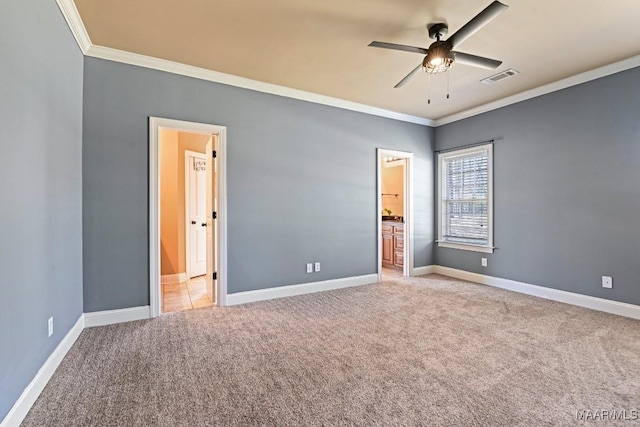 unfurnished bedroom featuring ornamental molding, light colored carpet, visible vents, and baseboards