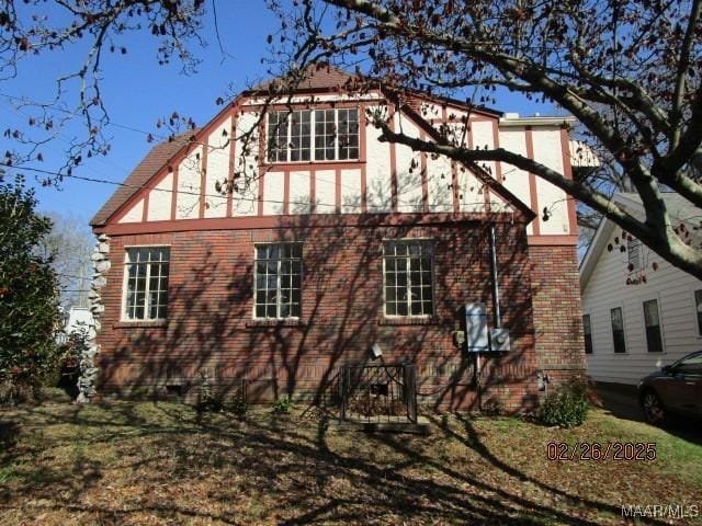 view of side of property featuring brick siding