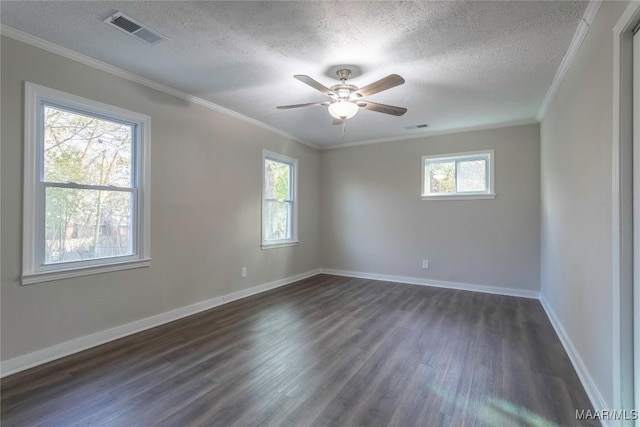 unfurnished room with a wealth of natural light, dark wood-style flooring, and visible vents