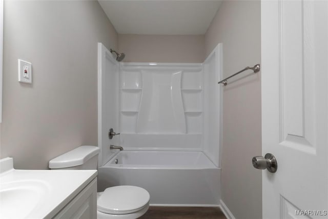 bathroom featuring toilet, shower / bathing tub combination, wood finished floors, and vanity