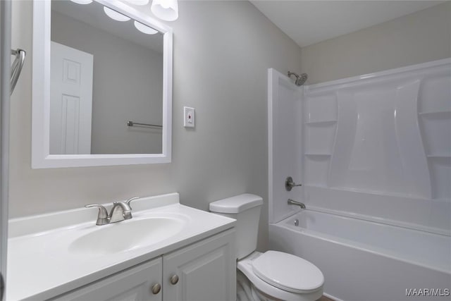 bathroom with toilet, shower / bathing tub combination, and vanity