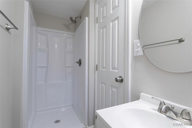 bathroom featuring a stall shower and vanity