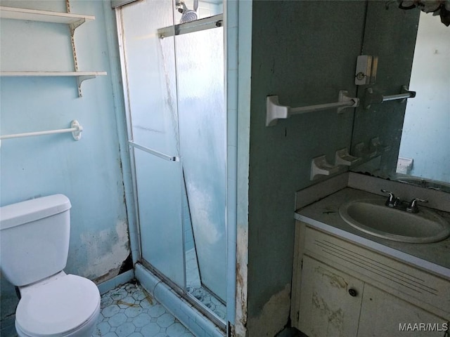 full bathroom with toilet, a stall shower, and vanity