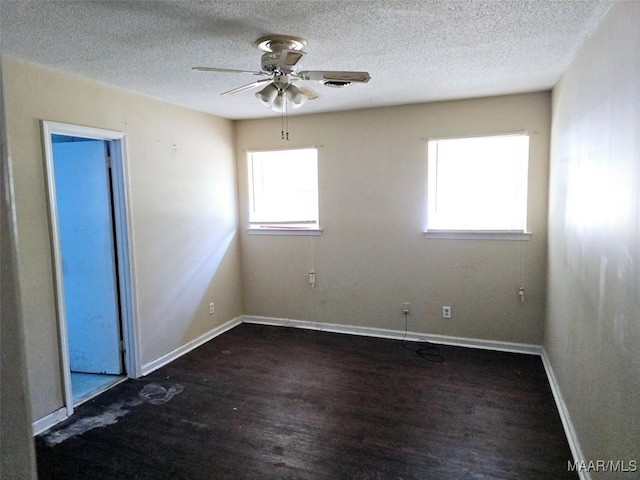 unfurnished room featuring ceiling fan, a textured ceiling, baseboards, and wood finished floors