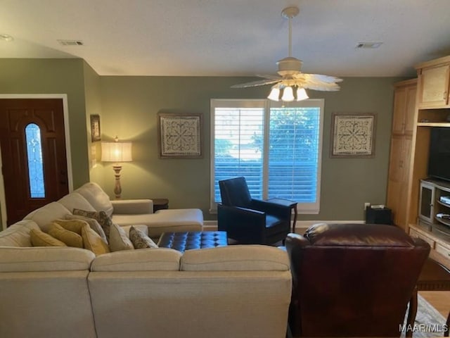 living area with visible vents and a ceiling fan