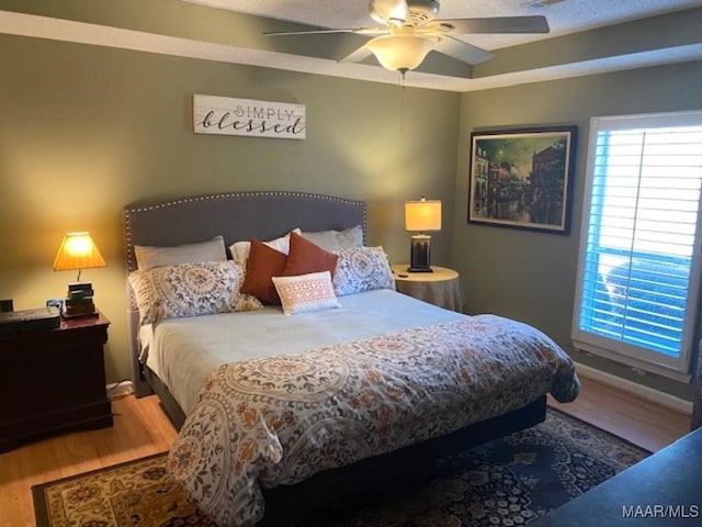 bedroom featuring wood finished floors and a ceiling fan