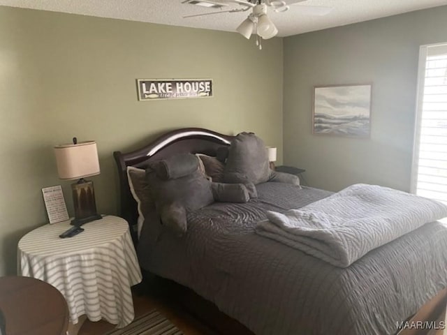 bedroom with a textured ceiling and ceiling fan