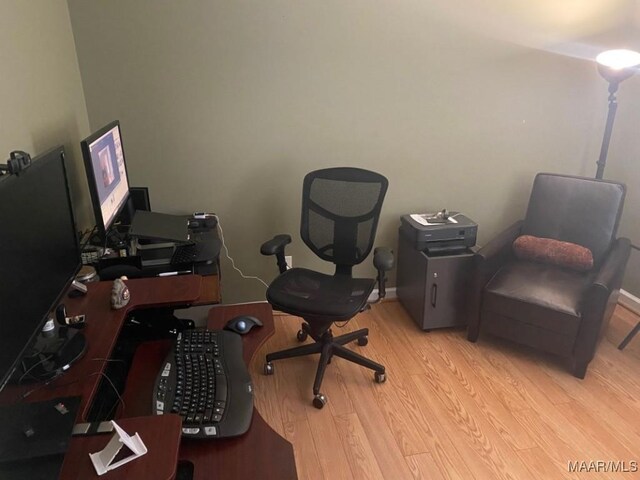 office featuring baseboards and wood finished floors