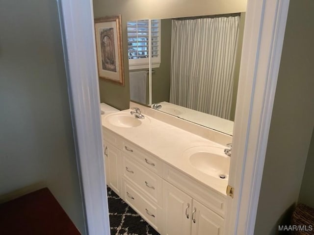 full bath with double vanity and a sink