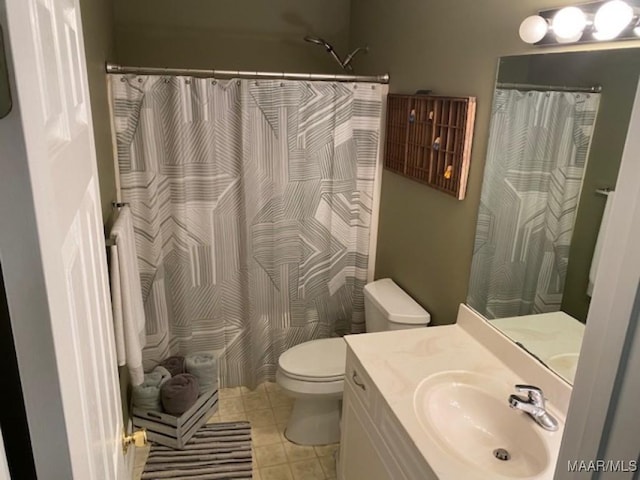 bathroom with toilet, curtained shower, vanity, and tile patterned floors