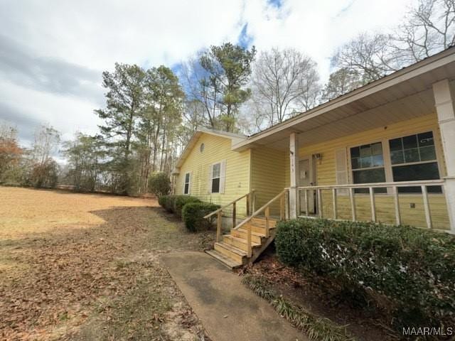 view of side of property featuring a porch