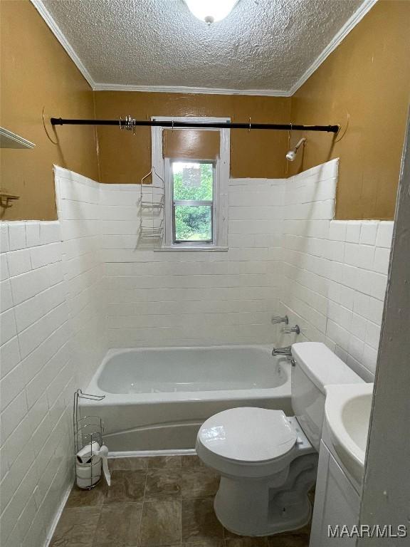 bathroom featuring tile walls, crown molding, a textured ceiling, and toilet