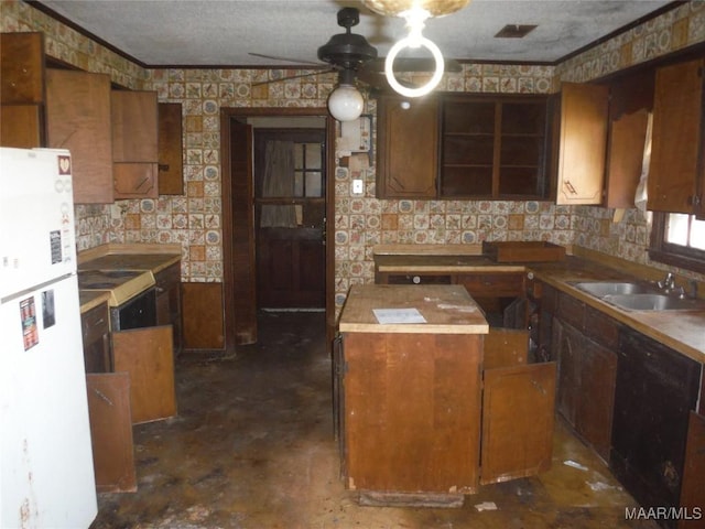 kitchen featuring wallpapered walls, dishwasher, a kitchen island, freestanding refrigerator, and a sink