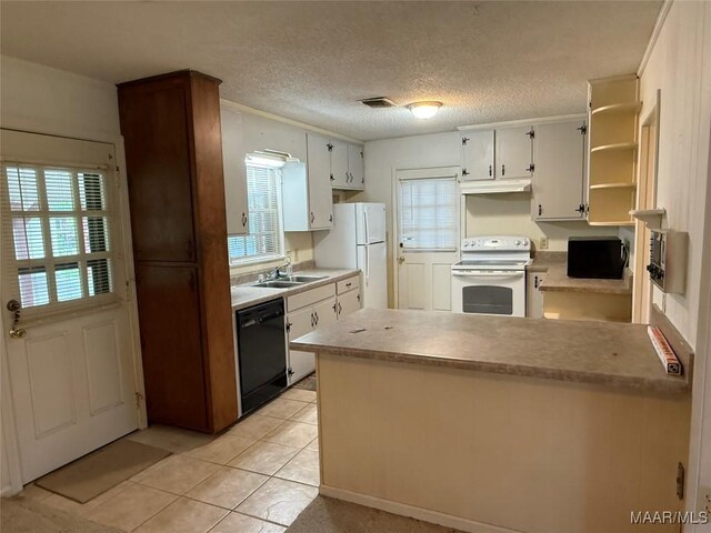 20 Glendale Dr, Selma, AL 36701 - kitchen with white appliances, a peninsula, visible vents, under cabinet range hood, and a sink