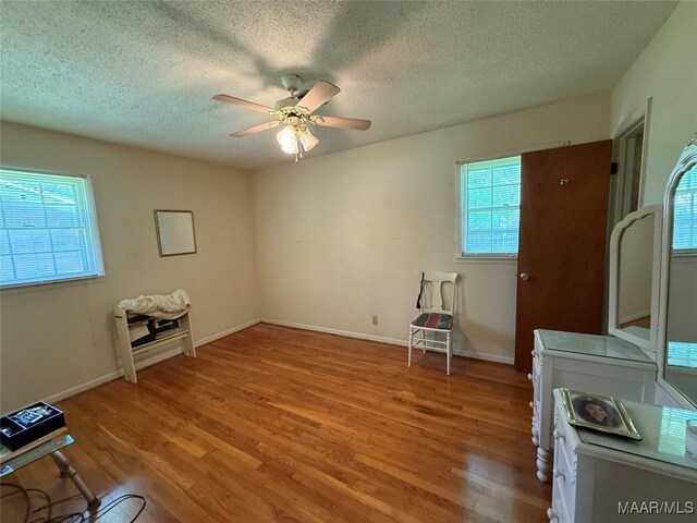 20 Glendale Dr, Selma, AL 36701 - misc room featuring baseboards, light wood-type flooring, a ceiling fan, and a textured ceiling
