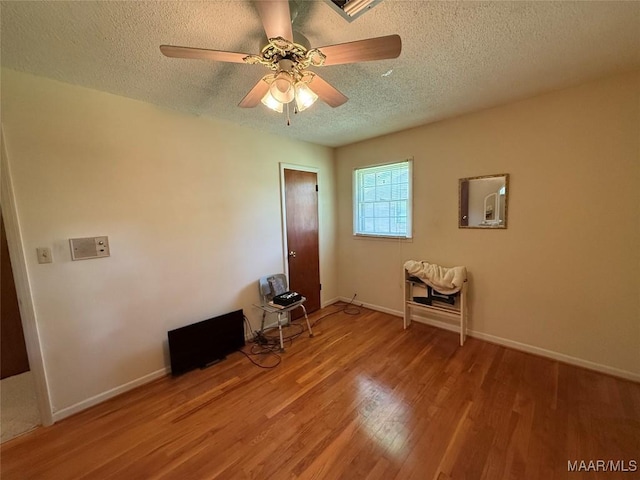 20 Glendale Dr, Selma, AL 36701 - empty room with ceiling fan, baseboards, wood finished floors, and a textured ceiling