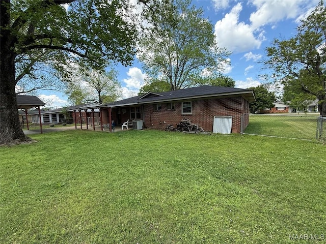 20 Glendale Dr, Selma, AL 36701 - rear view of property featuring a yard, fence, and brick siding