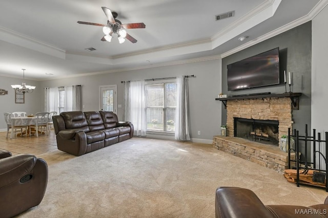 carpeted living area featuring a raised ceiling, visible vents, a fireplace, and baseboards