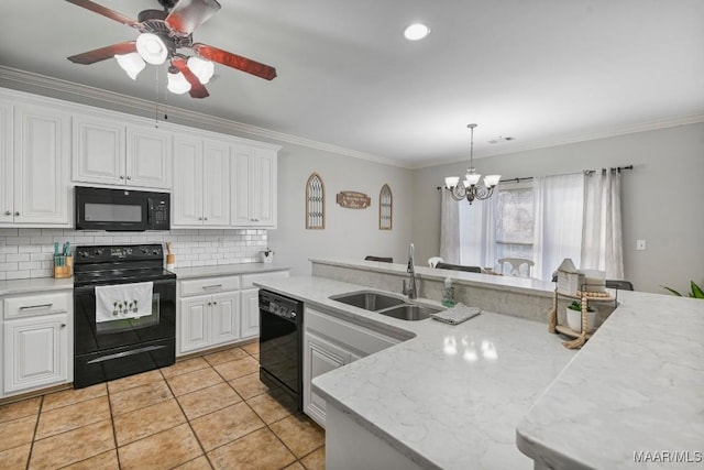 kitchen with black appliances, decorative backsplash, a sink, and crown molding