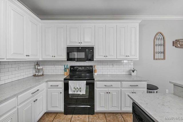 kitchen featuring tasteful backsplash, white cabinets, light stone counters, and black appliances