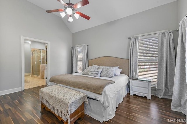 bedroom with baseboards, connected bathroom, ceiling fan, wood finished floors, and vaulted ceiling