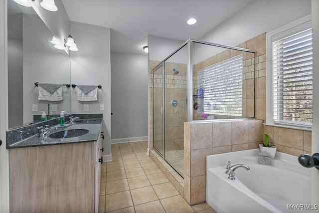 full bath with a bath, tile patterned flooring, a sink, and a shower stall