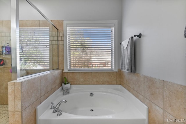 bathroom featuring a garden tub and tiled shower