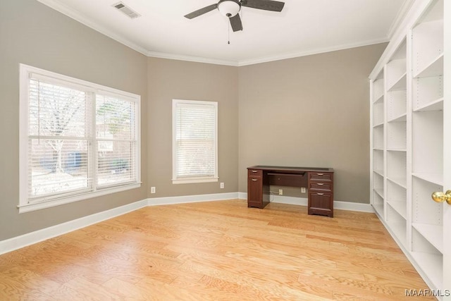 unfurnished office featuring ornamental molding, light wood finished floors, visible vents, and baseboards