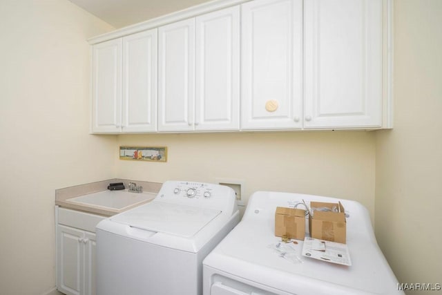 laundry room featuring cabinet space, a sink, and washer and clothes dryer