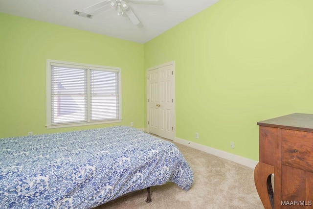 bedroom featuring carpet floors, visible vents, baseboards, and a ceiling fan