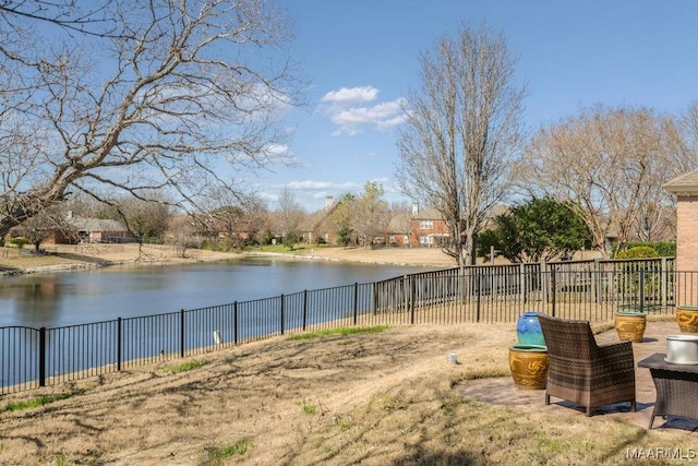 view of yard featuring a water view and fence