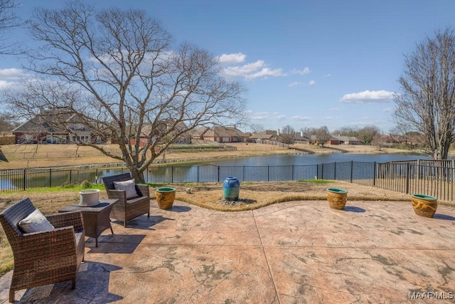 view of patio / terrace featuring a fenced backyard and a water view