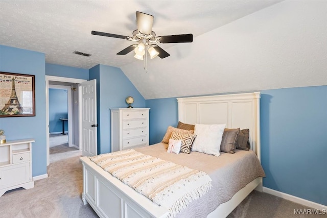 bedroom with light carpet, vaulted ceiling, visible vents, and baseboards