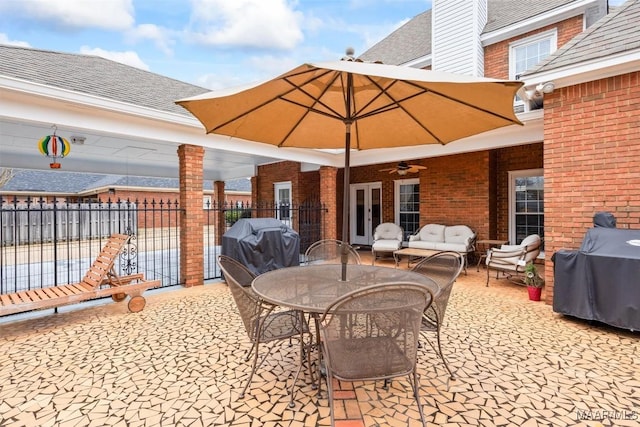 view of patio / terrace with french doors, area for grilling, fence, and an outdoor living space