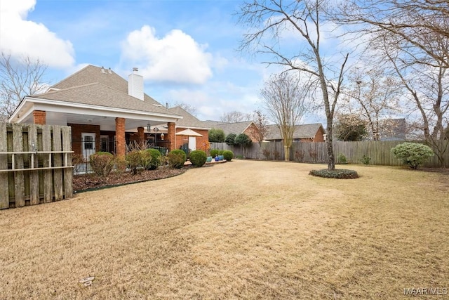 view of yard with a fenced backyard