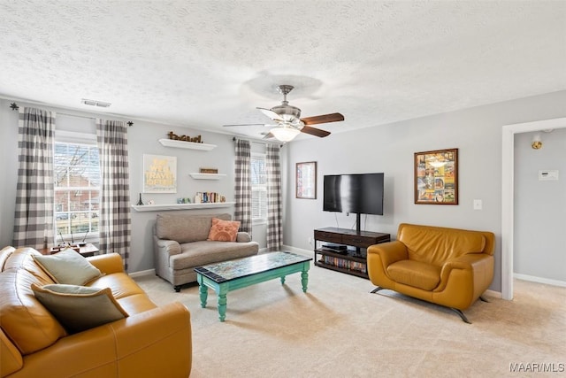 living room with ceiling fan, carpet flooring, visible vents, and baseboards