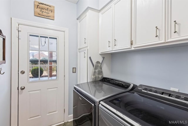 clothes washing area featuring cabinet space and independent washer and dryer