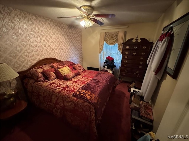 bedroom with ceiling fan and wallpapered walls