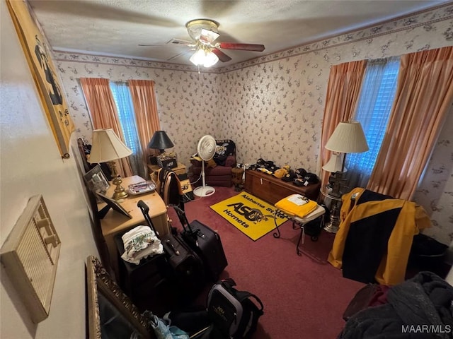 living area with wallpapered walls, carpet, ceiling fan, and a textured ceiling