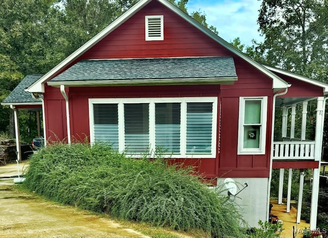 view of property exterior with a shingled roof