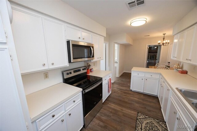 kitchen featuring visible vents, an inviting chandelier, appliances with stainless steel finishes, white cabinetry, and a peninsula