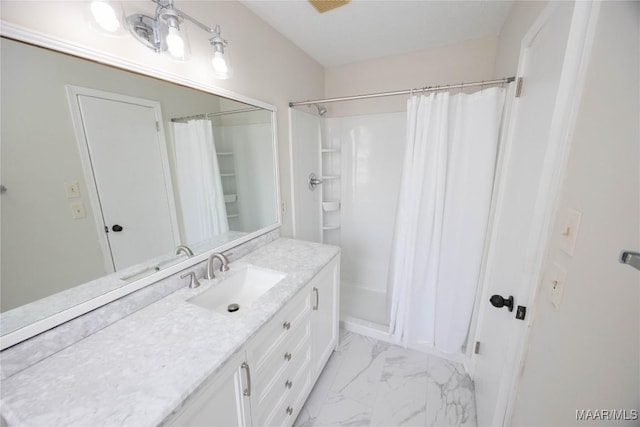 full bath with a shower with curtain, marble finish floor, and vanity