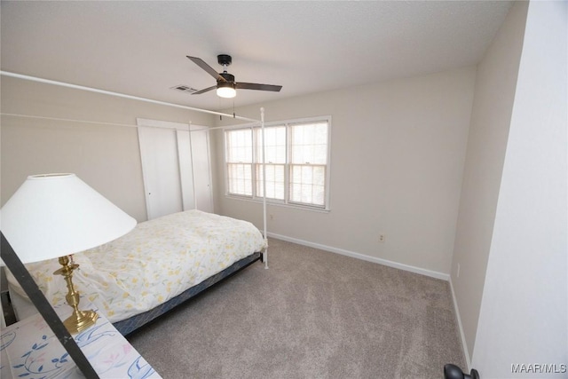 carpeted bedroom with a ceiling fan, visible vents, and baseboards