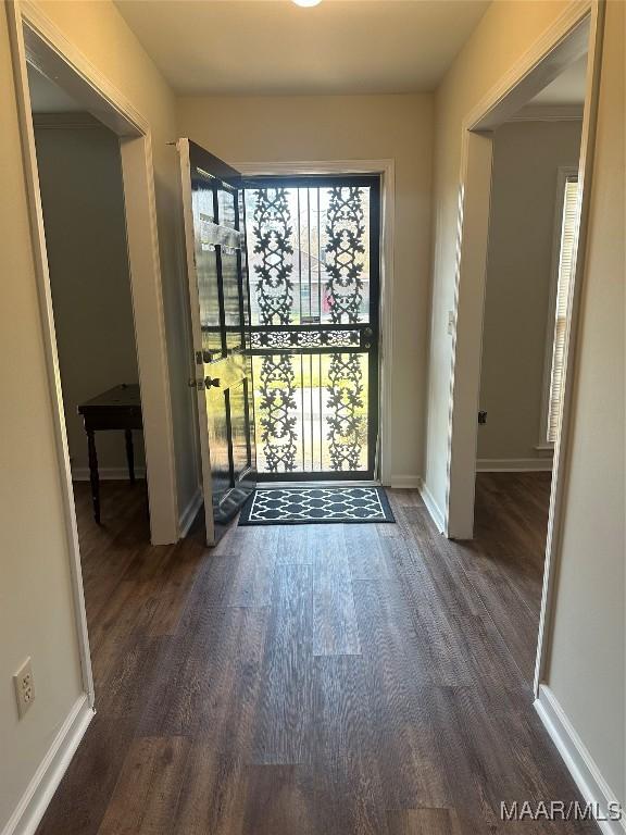 foyer with baseboards and dark wood finished floors