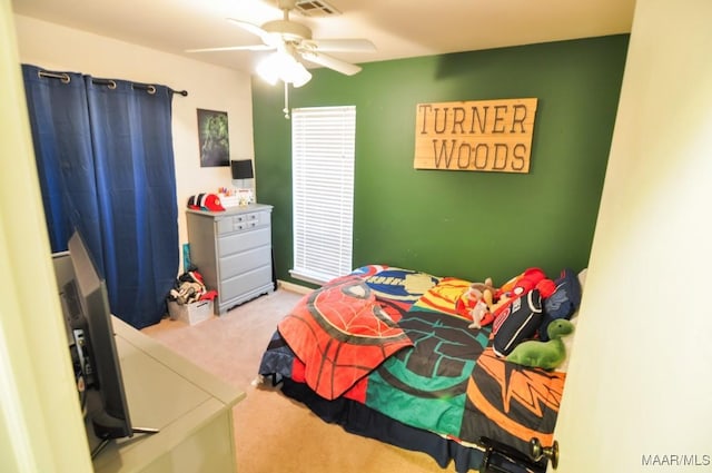 carpeted bedroom featuring visible vents and ceiling fan