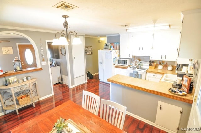 kitchen with ornamental molding, white appliances, visible vents, and dark wood-style flooring