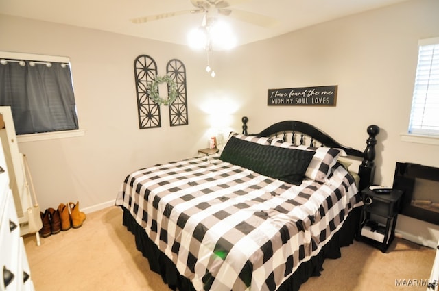 bedroom with carpet flooring, a ceiling fan, and baseboards