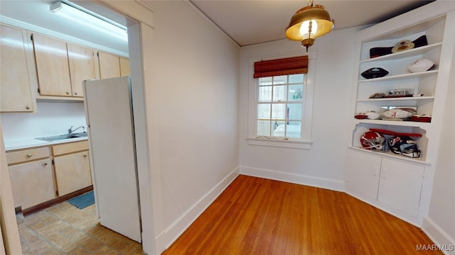 932 E Fairview Ave, Montgomery, AL 36106 - unfurnished dining area featuring light wood-style flooring, baseboards, and a sink