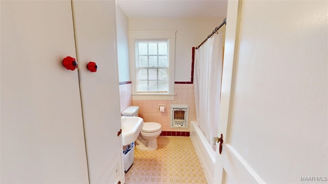 932 E Fairview Ave, Montgomery, AL 36106 - full bath with a wainscoted wall, tile walls, heating unit, toilet, and shower / tub combo