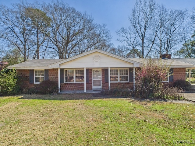 ranch-style house with brick siding, a front lawn, and a chimney